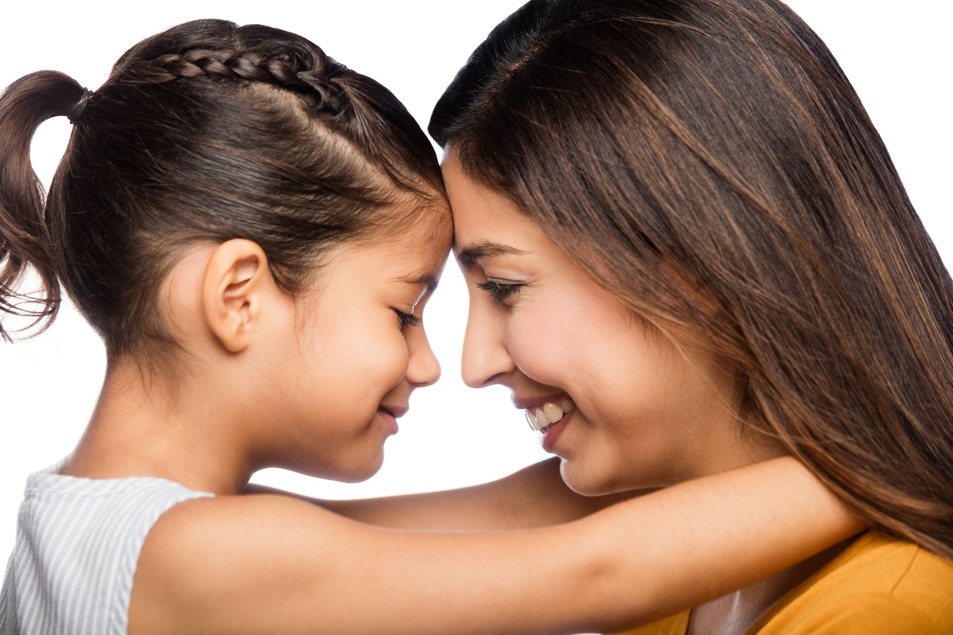 Mother and daughter smiling face to face